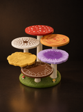 Mushroom Grove coaster set: six mushroom-cap coasters on cream stems rising from a moss-green base
